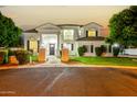 Elegant two-story home featuring a grand entrance, well-manicured lawn, and mature trees at 2625 N 24Th St # 13, Mesa, AZ 85213
