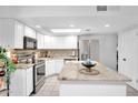 Bright kitchen featuring white cabinets, stainless steel appliances, granite countertops, and a large island at 625 S Daley --, Mesa, AZ 85204