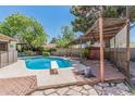 Sparkling in-ground pool with a diving board and wooden pergola covered spa at 637 W 6Th St, Mesa, AZ 85201