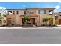 Inviting two-story townhouse with a stone facade, landscaped front yard, and covered entrance at 759 E Lark St # 202, Gilbert, AZ 85297
