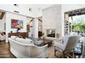 Spacious living room featuring a stone fireplace, wood floors, and views to other living areas at 10057 E Blue Sky Dr, Scottsdale, AZ 85262