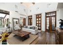 Open living room featuring wood floors, natural light, and elegant furnishings for entertaining at 10057 E Blue Sky Dr, Scottsdale, AZ 85262
