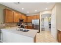 Well-appointed kitchen featuring stainless steel appliances, tile backsplash, and ample counter space at 10224 S 175Th Ave, Goodyear, AZ 85338