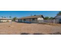 Single-story home featuring a classic facade and a spacious front yard at 10713 E Oasis Dr, Mesa, AZ 85208