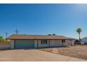 Inviting single-story home featuring a classic facade and well-kept yard, perfect for comfortable living at 10713 E Oasis Dr, Mesa, AZ 85208