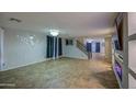 Open living room featuring tiled floors, custom fireplace, and staircase access to the upper level at 10817 W Pierson St, Phoenix, AZ 85037