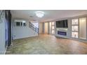 Stylish living room with tiled floors, custom fireplace, and decorative lighting at 10817 W Pierson St, Phoenix, AZ 85037