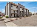 Exterior view of a multi-unit apartment building featuring gray accents and access stairs at 1215 E Lemon St # 222, Tempe, AZ 85281
