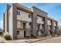 Exterior view of apartment building featuring multiple units, stairs, gray accents, and a red tile roof at 1215 E Lemon St # 222, Tempe, AZ 85281