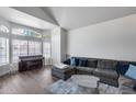 Open-concept living room with large windows, piano, and comfortable sectional sofa at 1266 S Harrington St, Gilbert, AZ 85233