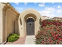 Inviting gated front entry featuring desert landscaping and an arched entryway at 12738 W Nogales Dr, Sun City West, AZ 85375