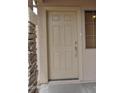 Close-up of a front door with stone trim and neutral paint at 17810 W Marshall Ln, Surprise, AZ 85388