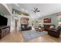 Spacious living room featuring a large leather sofa, tile flooring, and neutral paint colors at 18058 W Weatherby Dr, Surprise, AZ 85374