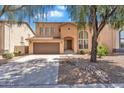 Charming two-story home with desert landscaping, a two-car garage, and inviting curb appeal at 18525 N Larkspur Dr, Maricopa, AZ 85138