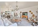 Open-concept living area showcasing chandelier lighting, decorative accents, and comfortable seating arrangements at 18650 N 91St Ave # 3701, Peoria, AZ 85382