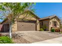 Charming single-Gathering home showcasing desert landscaping and a two-car garage at 20592 E Reins Rd, Queen Creek, AZ 85142