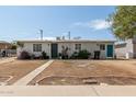Quaint single-level home with a simple landscape, featuring a compact yard at 2221 E Lynne Ln, Phoenix, AZ 85042