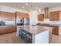 Modern kitchen features stainless steel appliances, granite countertops, and a large island with seating at 23038 E Twilight Dr, Queen Creek, AZ 85142