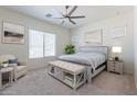 Serene main bedroom featuring neutral colors, a ceiling fan, and large windows at 23038 E Twilight Dr, Queen Creek, AZ 85142