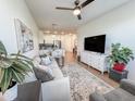 Bright living room with a neutral color palette, modern decor, and an open view to the kitchen and dining area at 2314 E Hidalgo Ave, Phoenix, AZ 85040