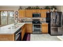Well-equipped kitchen featuring stainless steel appliances, granite countertops, and plenty of storage space at 25821 N 41St Dr, Phoenix, AZ 85083