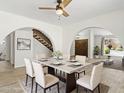 Elegant dining room with modern table and chairs, showcasing arched doorways and stylish decor at 2619 S Los Altos --, Mesa, AZ 85202