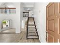 Bright and inviting foyer with a staircase and wood-look tile flooring throughout at 2619 S Los Altos --, Mesa, AZ 85202