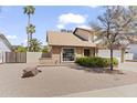 View of the home's front exterior, showcasing the desert landscaping, and brick accents at 2619 S Los Altos --, Mesa, AZ 85202
