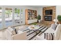 Cozy living room with brick fireplace, French doors, and comfortable seating at 2619 S Los Altos --, Mesa, AZ 85202