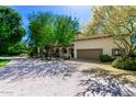 Inviting home showcasing lush landscaping, a tile roof, and a spacious driveway, perfect for comfortable living and curb appeal at 3006 N Manor W Dr, Phoenix, AZ 85014
