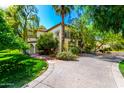 Stately two-story home with a lush green yard and a circular driveway provides instant curb appeal at 3006 N Manor W Dr, Phoenix, AZ 85014