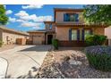 Charming two-story home featuring desert landscaping, a two car garage, and a welcoming covered entryway at 3099 E Claxton Ct, Gilbert, AZ 85297