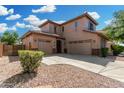 Spacious home featuring a three-car garage and desert landscaping with a well maintained yard at 3099 E Claxton Ct, Gilbert, AZ 85297