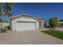 Charming single-story home featuring a well-manicured lawn, desert landscaping, and a two-car garage at 3802 W Sheffield Ave, Chandler, AZ 85226
