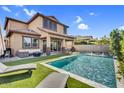 The sparkling pool features fountains and is surrounded by artificial turf and an outdoor seating area at 3960 E Appaloosa Rd, Gilbert, AZ 85296