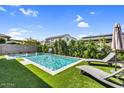 The pool is surrounded by artificial turf, landscaping, and lounge chairs at 3960 E Appaloosa Rd, Gilbert, AZ 85296