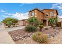 Attractive two-story home with desert landscaping, including cacti and rock features at 41227 W Granada Dr, Maricopa, AZ 85138