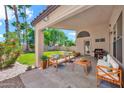 Inviting covered patio with comfortable seating, a grill, and views of the backyard at 4811 W Oakland St, Chandler, AZ 85226