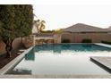 Inviting pool featuring desert landscaping with stone accents for a serene backyard escape at 5208 S Gold Leaf Pl, Chandler, AZ 85249