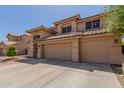Lovely desert home featuring a three-car garage, tile roof, and an arched entry for added curb appeal at 5215 W Del Rio St, Chandler, AZ 85226