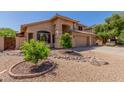 Charming tan home with well-maintained desert landscaping and a welcoming front entrance at 5215 W Del Rio St, Chandler, AZ 85226