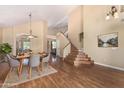 Bright, open living room with dining area, high ceilings, hardwood floors and staircase at 5215 W Del Rio St, Chandler, AZ 85226