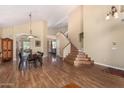 Inviting formal living and dining areas featuring high vaulted ceilings, elegant staircase, and wood-look flooring at 5215 W Del Rio St, Chandler, AZ 85226