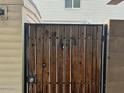 Wooden gate with metal frame and number 6624 painted on the front of the door at 6624 S Granada Dr, Tempe, AZ 85283