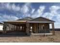 New home construction displaying the framing and Tyvek wrap, set against a bright sky in a desert landscape at 7713 W Avenida Del Rey --, Peoria, AZ 85383