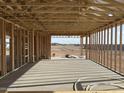 Interior view of a new home under construction displaying the framed opening and view at 7713 W Avenida Del Rey --, Peoria, AZ 85383