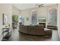 Open living room boasts vaulted ceilings, wood flooring, fireplace, and a view of the patio at 9540 N 114Th Way, Scottsdale, AZ 85259