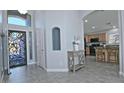 Bright foyer featuring tiled floors, decorative wrought iron door, high ceilings and an arched doorway at 1237 E Debbie Dr, San Tan Valley, AZ 85140