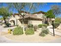 Inviting home with a red tile roof, lush desert landscaping, and a welcoming front yard at 19700 N 76Th St # 1058, Scottsdale, AZ 85255