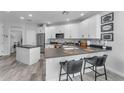Modern kitchen featuring an island with seating, stainless steel appliances, and stylish countertops at 2511 W Queen Creek Rd # 474, Chandler, AZ 85248